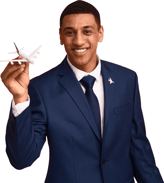 A man in a blue suit holds a small airplane model and smiles. He wears an airplane pin on his lapel. The context suggests aviation or travel services.