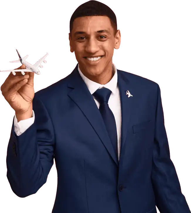 A man in a blue suit holds a small airplane model and smiles. He wears an airplane pin on his lapel. The context suggests aviation or travel services.